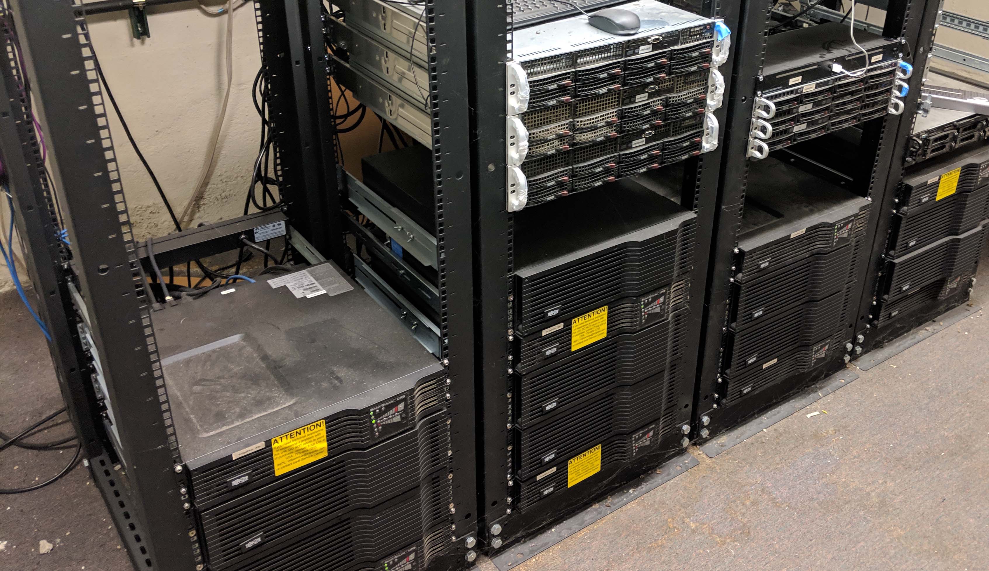 old server equipment in three racks
