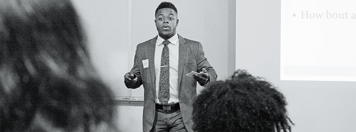 Photograph of a man giving a presentation.