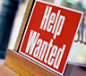A help wanted sign in a window