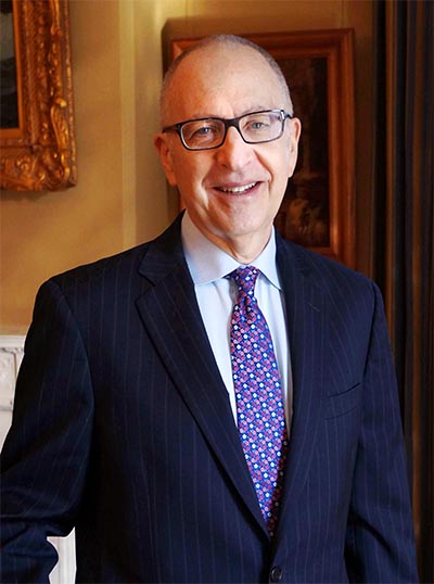 David Skorton standing in front of paintings