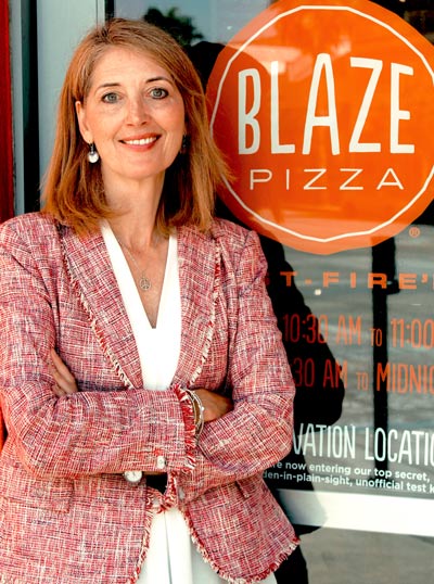 Elise Wetzel standing in front of a Blaze Pizza sign