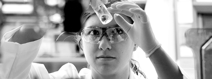 Picture of a woman holding a test tube.