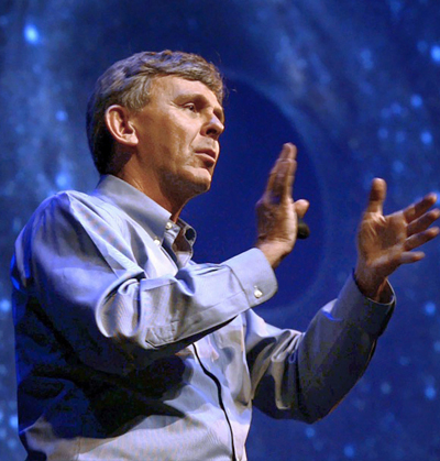 David giving a talk with a starry background behind him