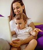 mother and baby looking at a laptop