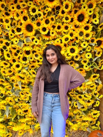 gisely torres in front of sunflowers